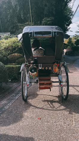 couple enjoying a rickshaw ride in a japanese garden