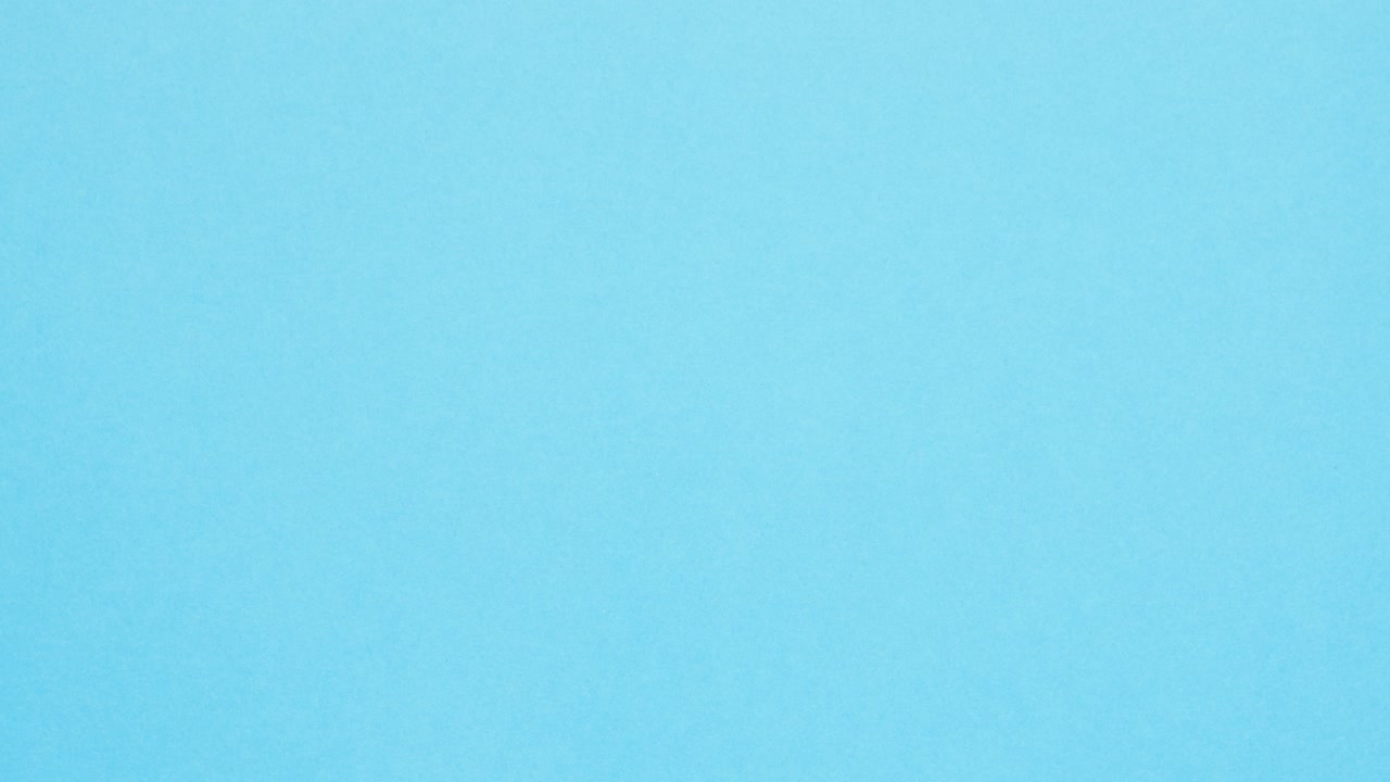 Green crumpled paper unfolds then refolds on blue in stop motion transition