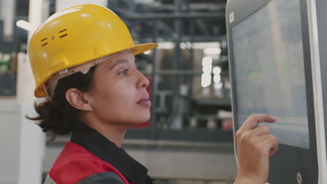 female engineer typing on touchscreen