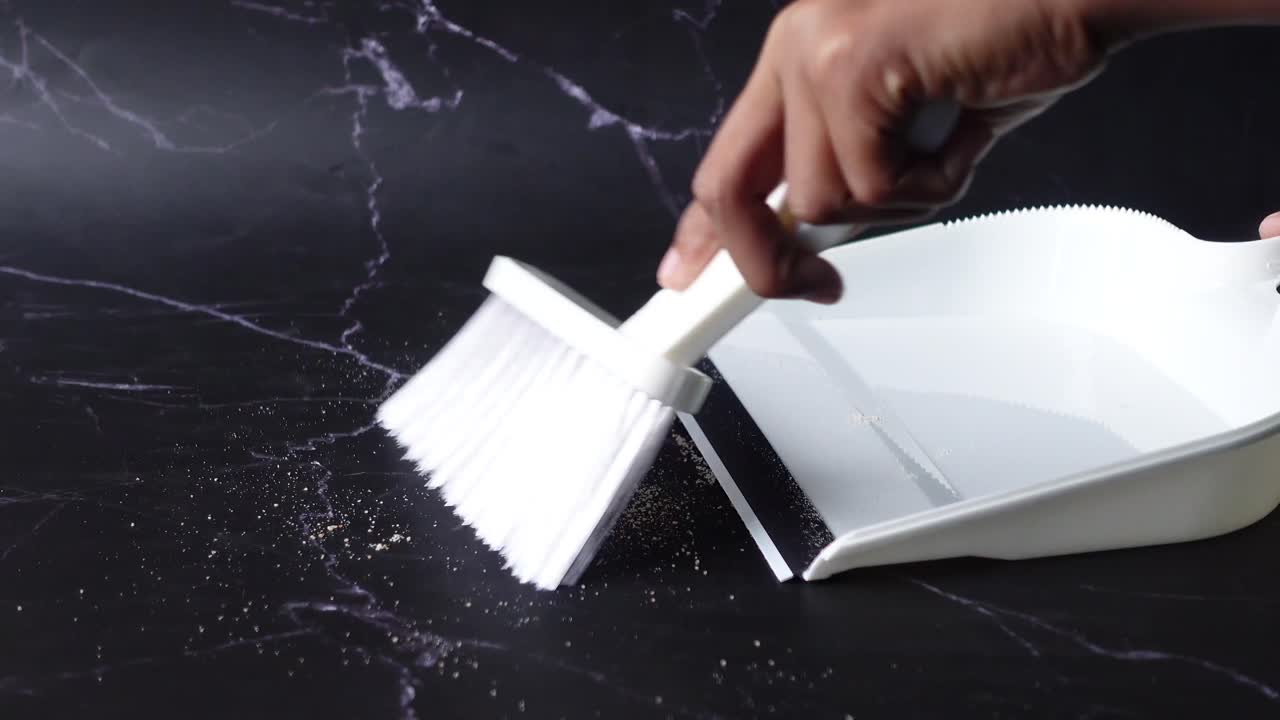 Floor dust with dust pan close up