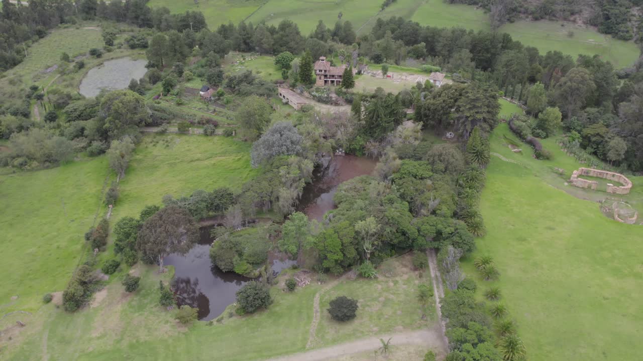 The camera glides over verdant gardens and winding trails that weave through dense forests, capturing the diversity of flora that thrives here. Short gimbal tilt down, roll right with yaw left.