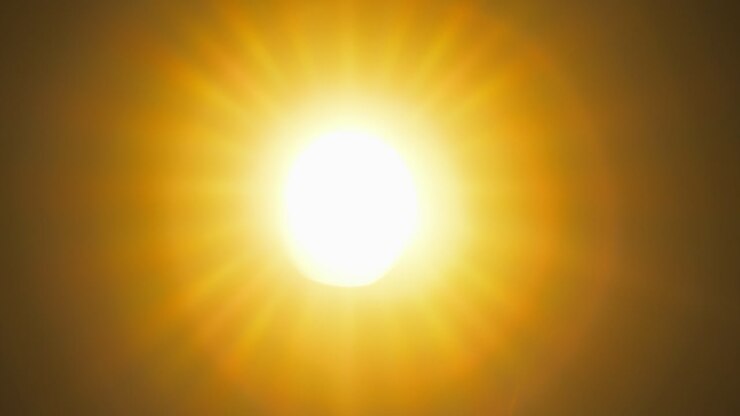 Light rays shining through old camera lens, while diaphragm blades are closing and zooming out