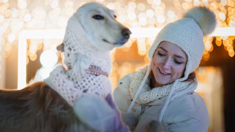 woman and saluki dog enjoying a winter evening