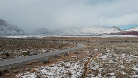 aerial drone shot of vehicles traveling along the scenic road