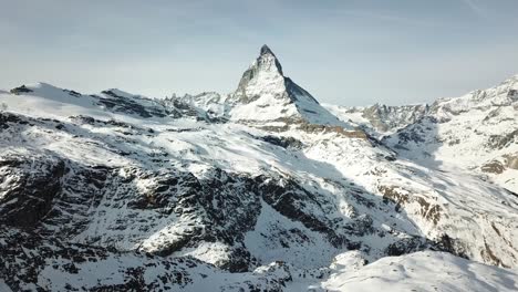 drone captures cinematic aerial view of the snow-covered matterhorn and surrounding mountains