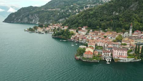 aerial: town of varenna is established near the coast of lake como