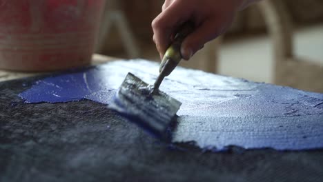 Close-Up-Shot-Of-Professional-Artisan-Spreading-Blue-Tint-With-Trowel