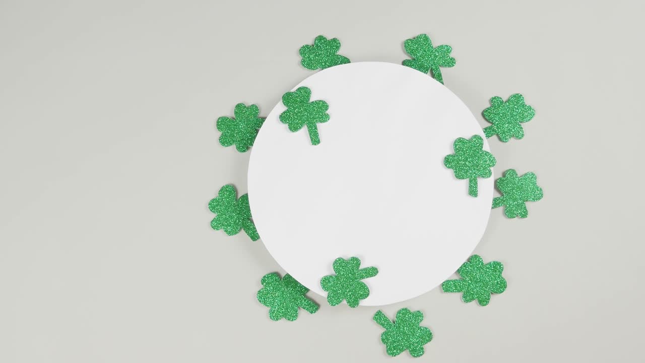 St. Patrick's Day shamrocks on a gray background. View from above. Copy space.