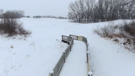 bridge-over-a-frozen-creek-in-winter,-part-of-a-cross-country-skiing-track-from-long-ago