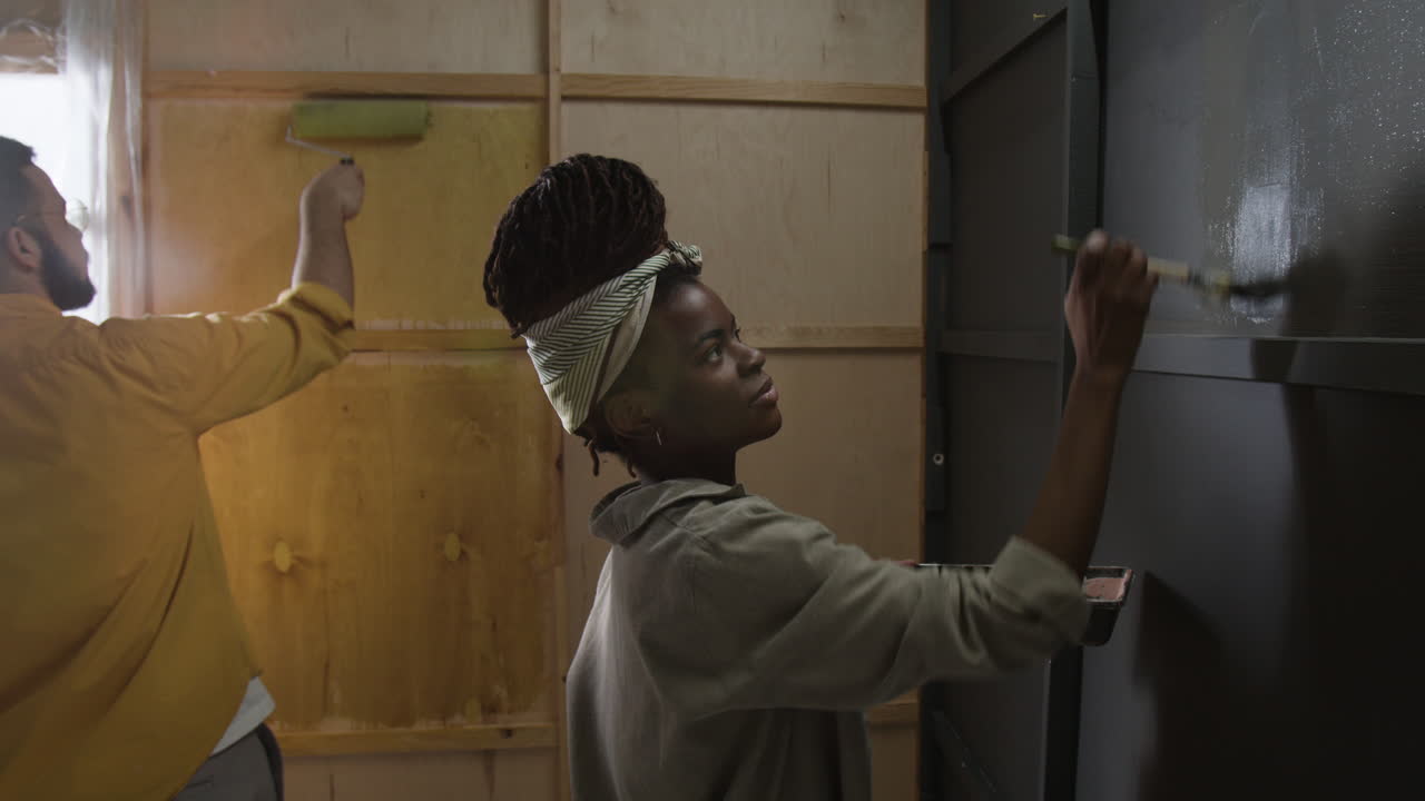 People Painting a Wall