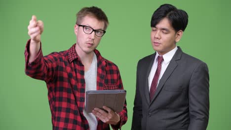 young handsome asian businessman and young scandinavian businessman working together