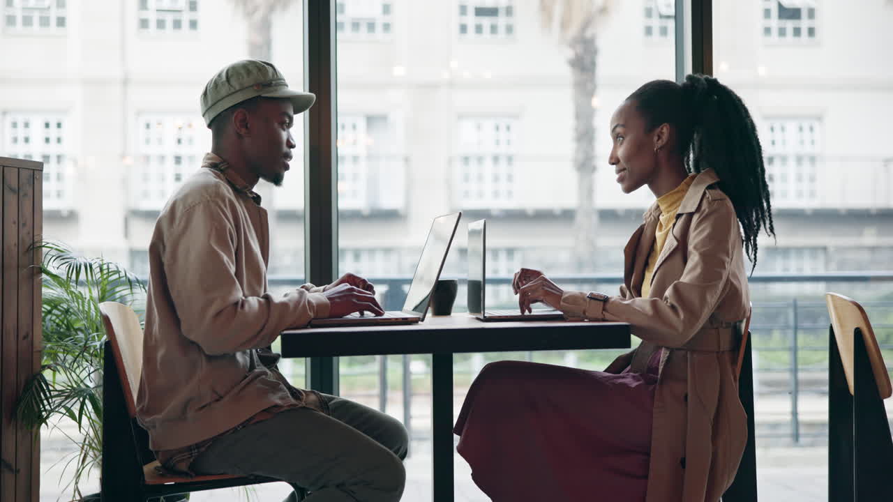 Cafe, black man and woman with a laptop