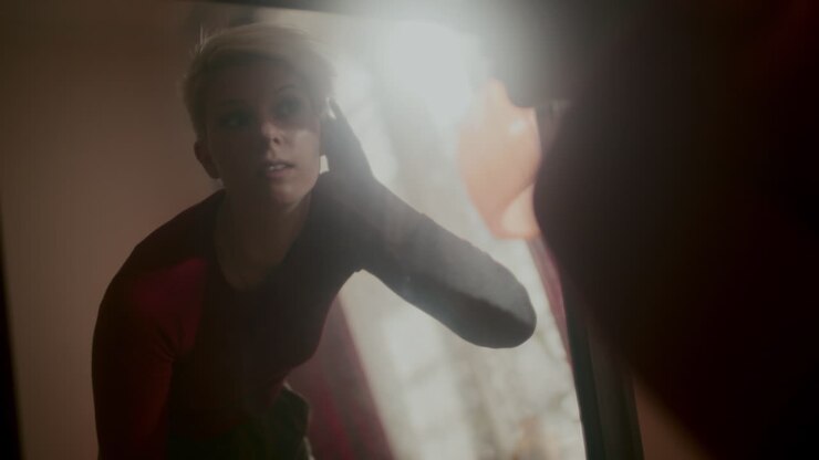 Woman Checking Appearance in a Mirror