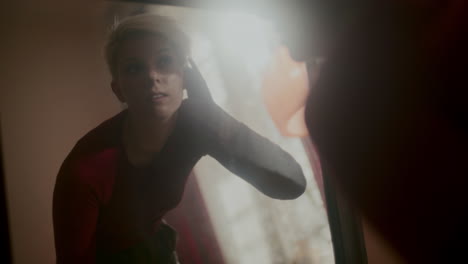 woman checking appearance in a mirror
