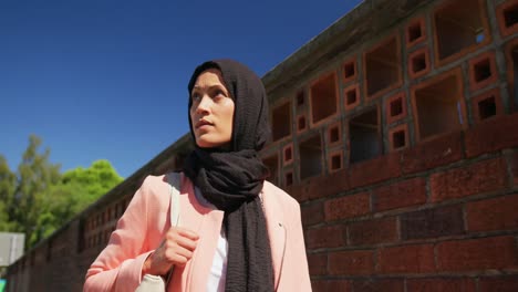 young woman wearing hijab out and about in the city