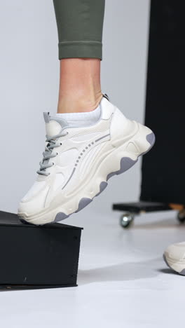 woman trying on white sneakers