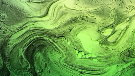 green ink paint marbling paint mixing effect flowing in slow motion.