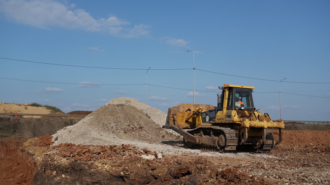 Bulldozer pushing gravel at a construction site