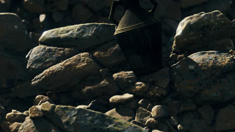 mysterious object hidden among rocks in remote outdoor location during daylight