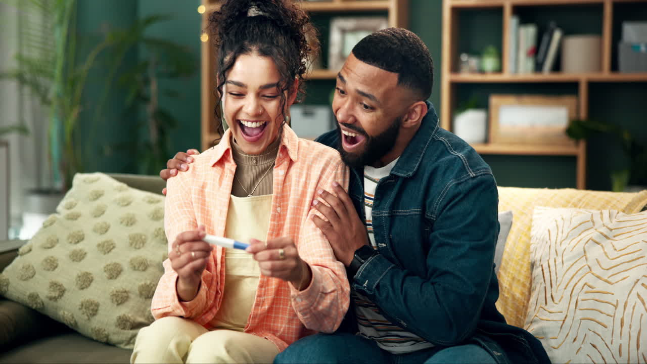 A joyful couple celebrates a positive pregnancy test