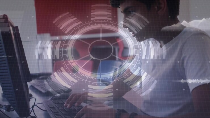 Teen boy placing hands on mouse keyboard typing code in computer lab while pulsing digital overlay