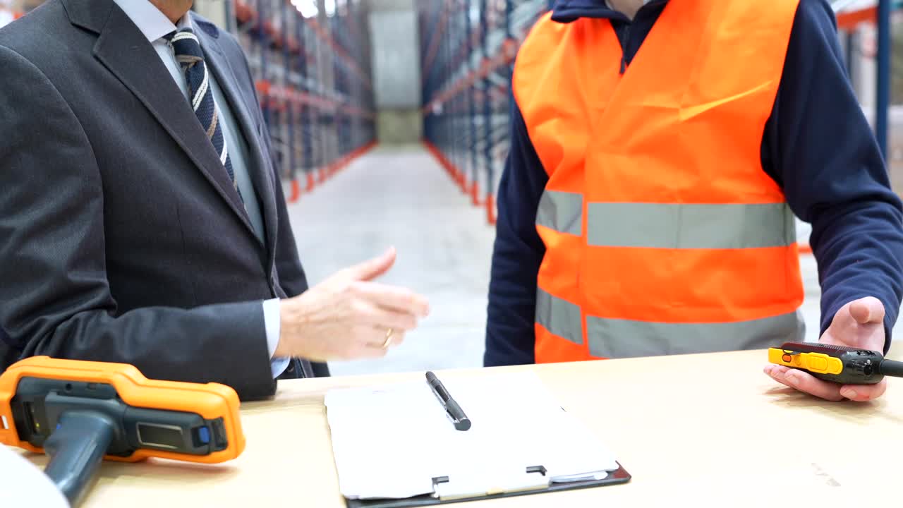 Handshake between Businessman and Warehouse Worker