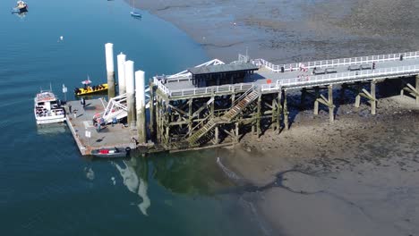 sunny beaumaris pier aerial view relaxing seaside waterfront tourist attraction welsh landmark close orbit right