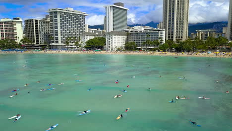 drone footage of surfers off of waikiki beach on the island of oahu, hawaii