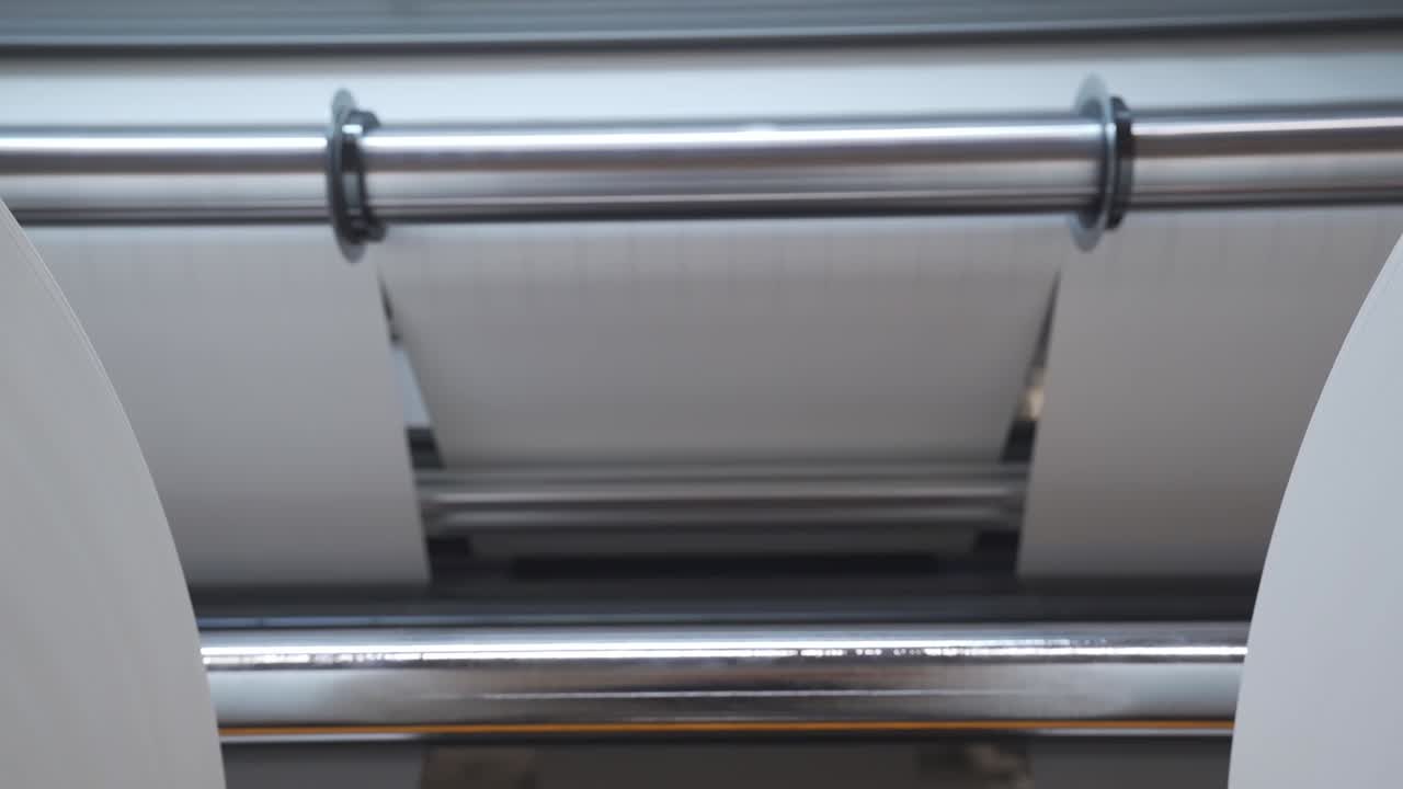 Huge Rolls Of Paper On Rolling Slitter For Custom Cutting In A Printing Factory