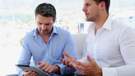 Businessmen-working-together-on-tablet-pc