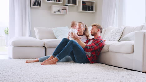 young white couple lifting and winding baby, side view