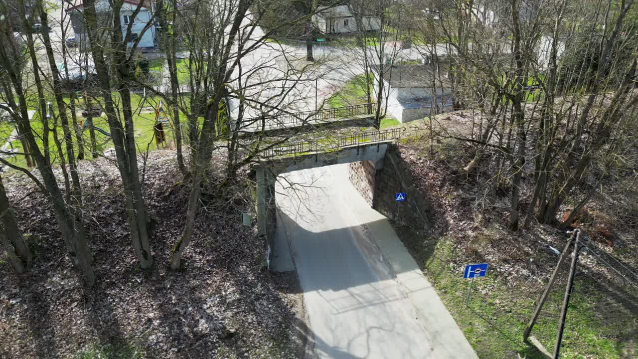Flying a drone over an old, disused railway viaduct under which there is a road for cars
