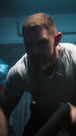 man working out with ropes in a gym