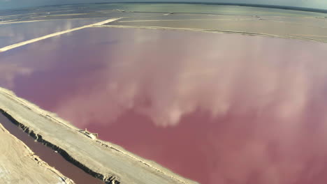 Pink-salt-ponds-with-sand-causeway-paths-in-between,-Yucatan,-Mexico