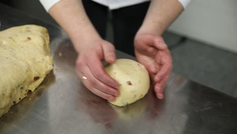 chef kneading dough for panettone