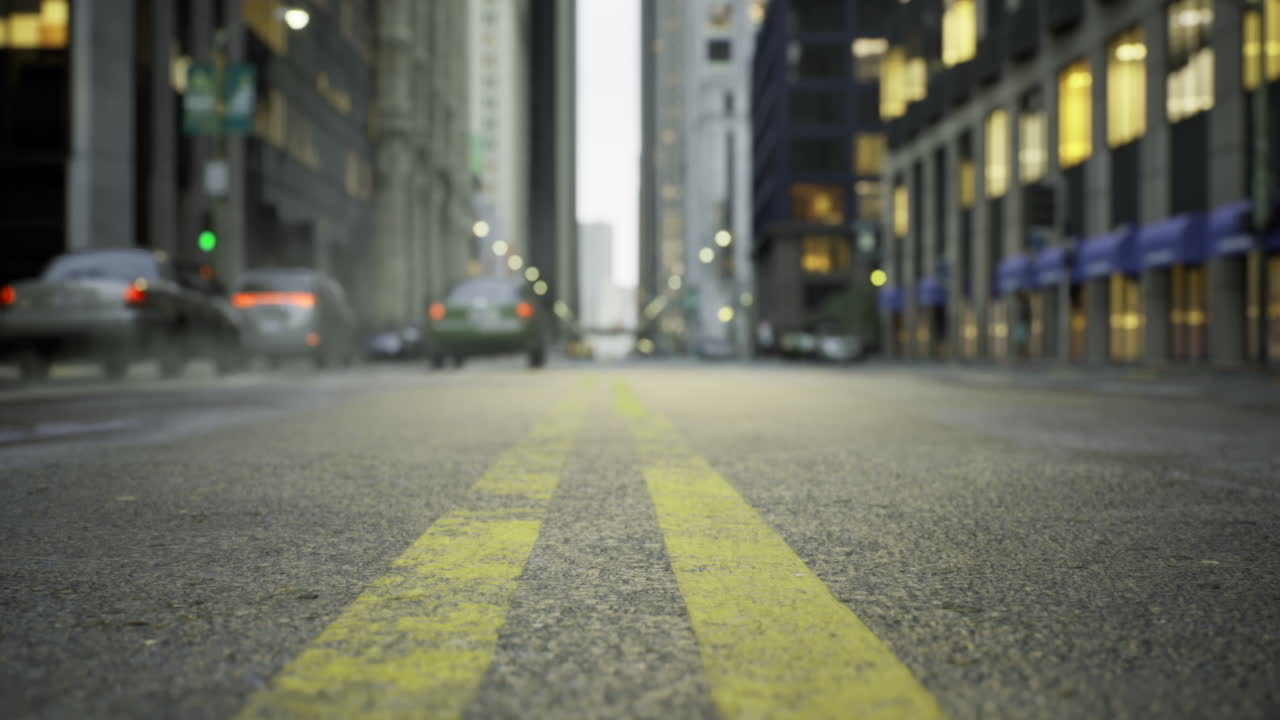 Street view in a bustling city during early evening with yellow lines