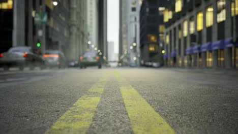 street view in a bustling city during early evening with yellow lines