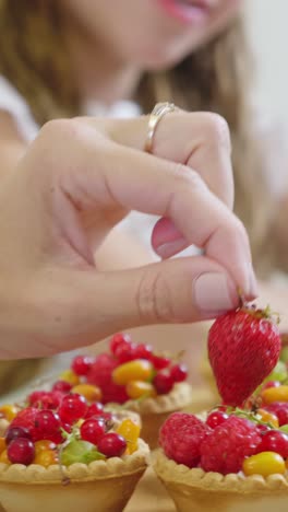 woman baking fruit tarts