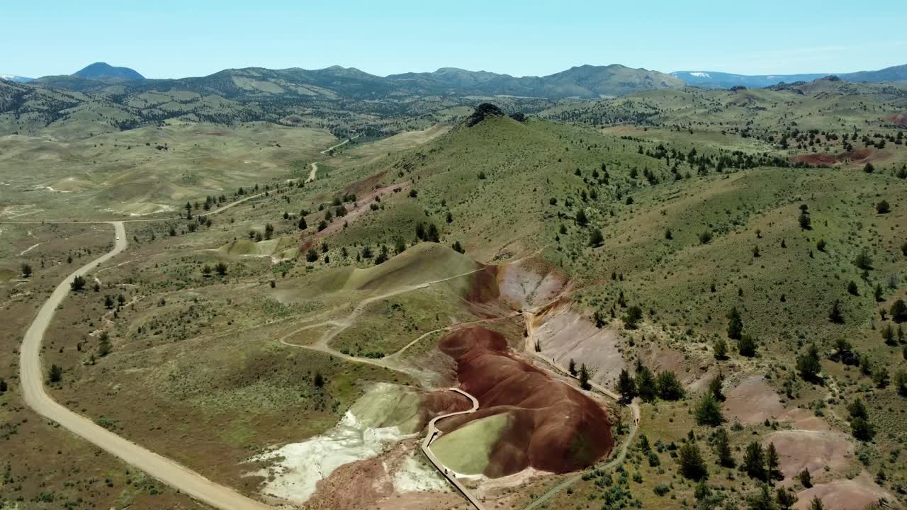 US, Oregon, Prineville, Painted Hills, 2025-05-05 - Drone view of the Painted Cove Trail in the John Day Fossil Beds National Monument in central Oregon. Red and Pink dirts with grass