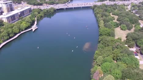 Aerial-View-of-the-Traffic-at-N-Interstate-35-Frontage-Rd-and-the-Lady-Bird-Lake-in-Austin,-Texas---zoom-out