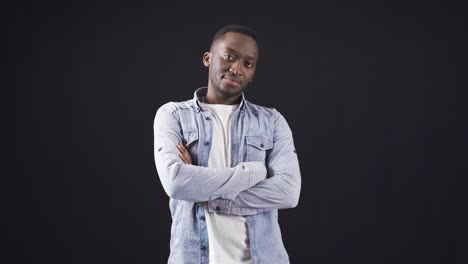 african handsome and attractive young man posing for camera on black background.