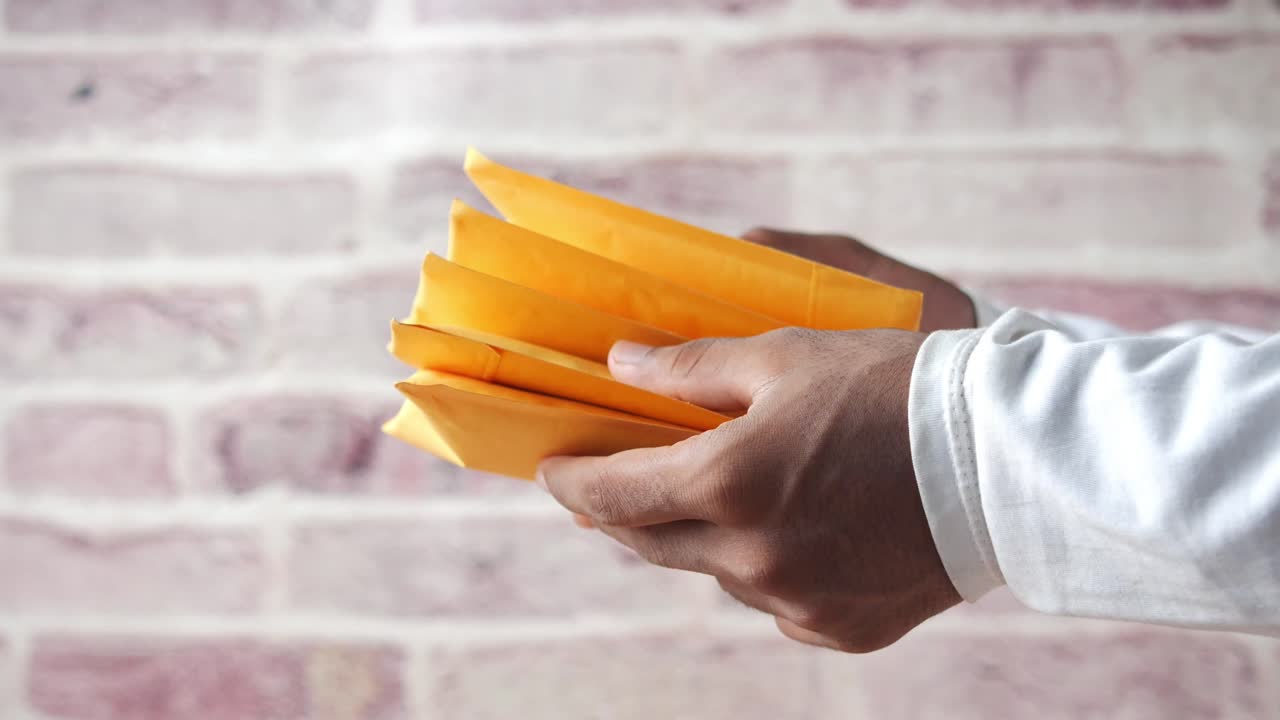 Hands holding a stack of envelopes