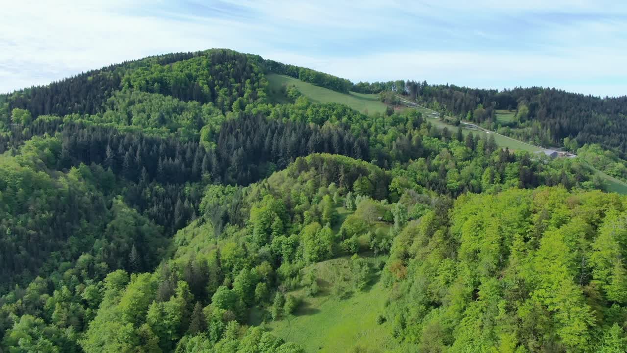 Wide angle dolly in drone shot of beautiful mountains, hills, grasslands,and valleys in Suhi Potok settlement in the Municipality of Kocevje in southern Slovenia