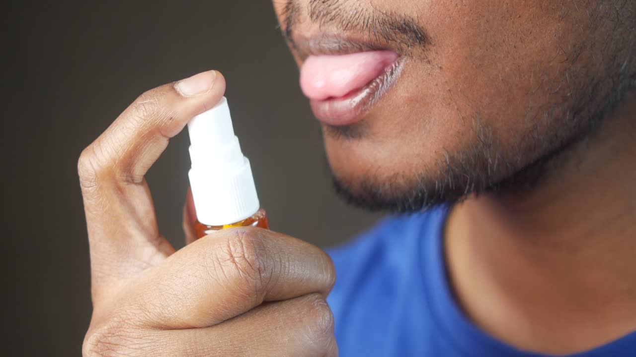 Man using mouth spray
