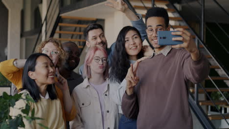 happy diverse group taking a selfie in a modern office