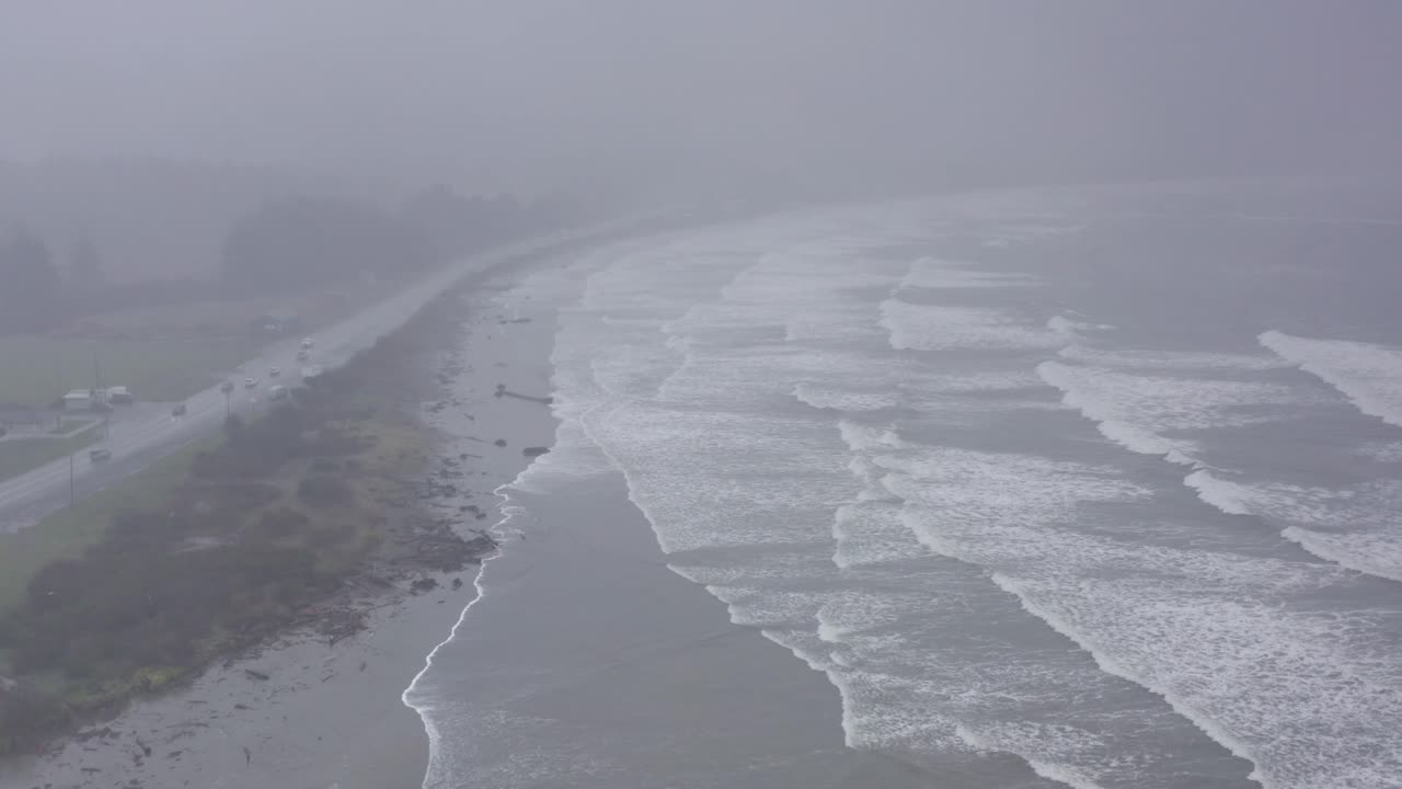 Aerial flyover shot tilting up to reveal a strong tidal surge at Crescent Beach in Crescent City, California. 4K