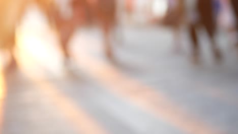 blurred motion of people walking in a city street