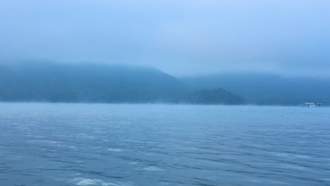 foggy river scene with distant mountains