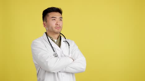 asian male doctor with stethoscope and lab coat on yellow background