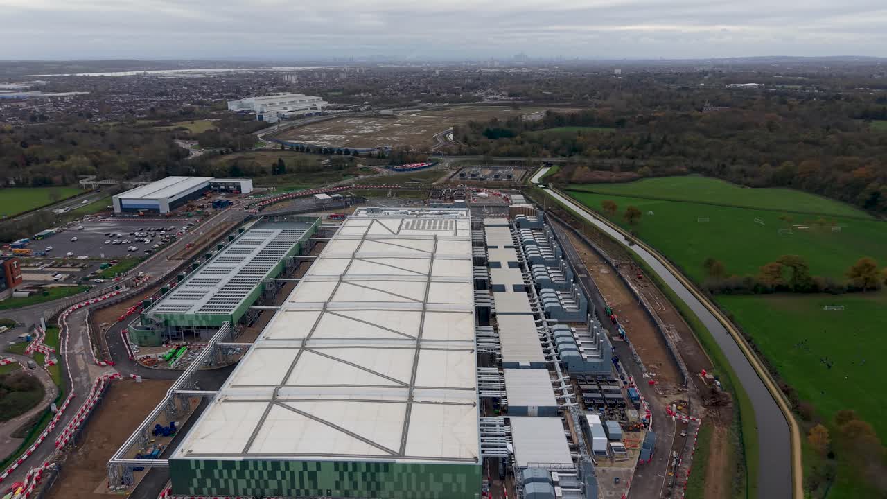 Sideways drone pan from the side of the Google Data Centre in Waltham Cross, Hertfordshire. Captures the length of the building, showcasing the expansive structure and surrounding landscape